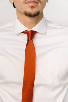 FINAL SALE Classy spice orange satin material Skinny style tie 2.5" wide by 56.5" long 100% Polyester Dry clean only * If returning, tie must arrive back to us in original packaging with tags still in place, or it will not be eligible for return. Business Satin Bow Tie, Business Tie With Satin Bow, Elegant Orange Suit And Tie Accessories For Formal Occasions, Elegant Orange Tie For Business, Classic Orange Tie For Business, Classic Orange Ties For Business, Orange Standard Tie For Business, Orange Business Tie, Orange Standard Business Tie