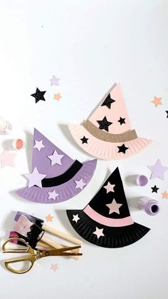 some paper plates and scissors are laying on the floor with stars around them, including one that has been cut out