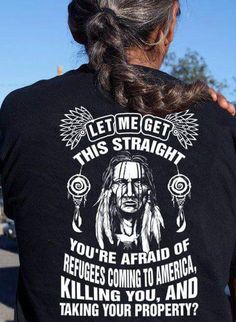 the back of a woman's black shirt that says, let me get this straight you're afraid of refugees coming to america killing you and taking your property?