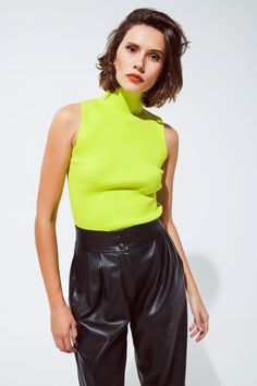 Brighten up your wardrobe with our Vibrant Lime Green Sleeveless Knit Top, a perfect blend of bold style and comfortable fit for your daily outfits. Eye-Catching Lime Green: This top's vivid lime green hue is sure to make a statement, adding a fresh and lively touch to your wardrobe. Sleek Turtleneck Design: The high turtleneck neckline adds a touch of elegance and sophistication, making it a versatile piece for various occasions. Comfortable Bodycon Fit: Crafted from a soft blend of 55% Viscose