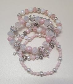 Beautiful pink and white pearl bracelets with silver spacers that are perfect for everyday wear whether it be out and about or a night out!  They are made with stretch cord so you can slip them on and off!  Set of 4 bands.  Can customize to an extent, please message me. Pink Silver Beaded Bracelet, Slytherin Accessories, Pink Bead Bracelet, Pink Bracelets, Girly Bracelets, Crystal Bead Jewelry, Pretty Jewelry Necklaces, White Pearl Bracelet, Pearl Bracelets