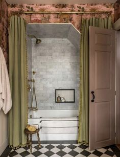 an open door leading to a bathroom with a checkered floor and white tub in the corner