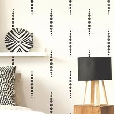 a black and white wallpaper with dots on it in a bedroom or living room