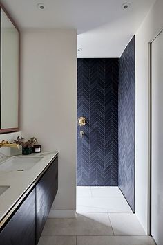 a bathroom with two sinks and a large mirror on the wall next to each other