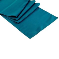 teal blue napkins folded on top of each other