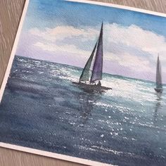 watercolor painting of two sailboats in the ocean