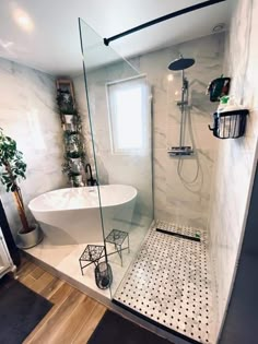 a white bath tub sitting inside of a bathroom next to a toilet and shower head