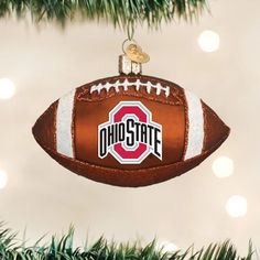 a football ornament hanging from a christmas tree