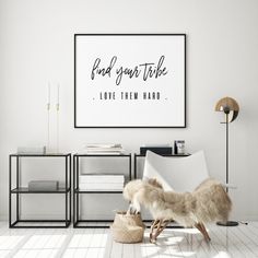 a white living room with an animal on the floor and a poster above it that says, find your style love them hard