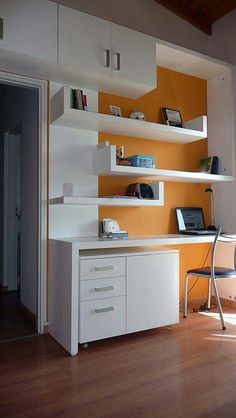 a room with a desk and shelves in it