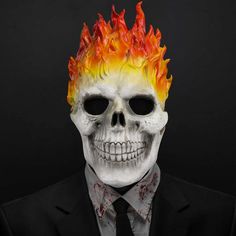 a man wearing a white skull mask with flames on it's head and tie