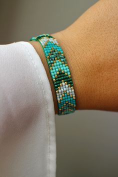 a woman's arm wearing a bracelet with beads