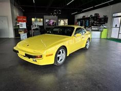 a yellow sports car parked in a garage