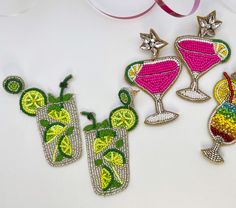 three embroidered appliques with cocktails on them