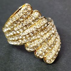 a gold ring with lots of diamonds on it