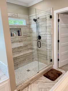 a walk in shower sitting inside of a bathroom