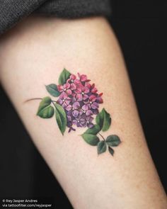 a woman's arm with a flower tattoo on the left side of her body