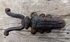 an old cast iron door handle on a wooden surface