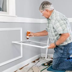 a man is painting the walls in his home