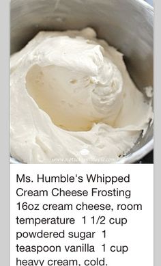 a bowl filled with white cream sitting on top of a table