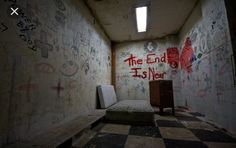 an empty room with graffiti all over the walls