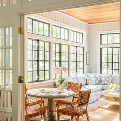 a living room filled with furniture and lots of windows