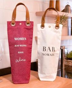 two wine bags sitting next to each other on a counter top with the words women just wanna have wine in them