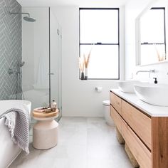 a bathroom with two sinks and a bathtub