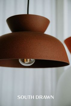 a brown lamp hanging from a ceiling in a room