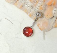 "Carnelian Belly Ring  Show off your beautiful belly! Simple non dangle style belly ring features a beautiful carnelian agate gemstone cabochon.    Belly ring is solid surgical steel with an 8mm gemstone cabochon. Belly button ring measures 7/8 inches long total length with a 7/16\" (11mm) wearable bar length.  For Belly Button Rings: https://www.etsy.com/shop/AllAboutClass?section_id=18474235&ref=shopsection_leftnav_1  All body jewelry sales are final!!  AllAboutClass DOES NOT accept any return Dangle Belly Rings, Belly Bars, Navel Rings, Belly Rings, Agate Gemstone, Belly Button Rings, Jewelry Sales, Body Jewelry, Agate