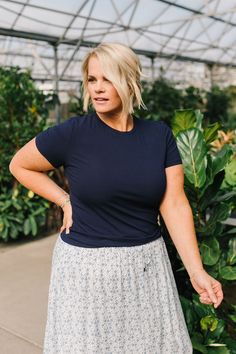 Introducing Jessa in Navy! This stylish top has a lightweight and breathable design, perfect for any occasion. The ribbed texture adds a touch of detail while the short sleeves keep you cool. With its fitted style, Jessa is flattering and comfortable. A must-have addition to your wardrobe! Model is wearing a large and is 5'5". Plus model is wearing an XL and is 5'7". This top is meant to be fitted. This top is paired with the Calla Maxi Skirt. Size Chart Length Bust S 21.5" 34" M 22" 36" L 23" 3 Hanging Fabric, Stylish Top, Fitted Style, Ribbed Texture, Keep Your Cool, Maxi Skirt, Short Sleeves, Navy, Wardrobe