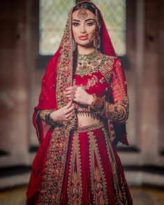 Pakistani Red Bridal Lehenga Choli Dupatta Dress is a traditional masterpiece to wear on the big day. This stunning Lehenga Choli is emblazoned with lavish goldwork and exquisite designs. Pearls, motifs, beads, and floral designs enhance the overall glamour of this stunning Pakistani Bridal Dress. Choli: The beautiful red choli having long sleeves is adorned with hand-crafted embellishments and goldwork. This stunning Bridal choli is embellished with beads, pearls, sequins, naqshi, and dabka. Fl Bridal Choli, Red Bridal Lehenga, Dupatta Dress, Pakistani Bridal Dress, Red Bridal Dress, Bridal Lehenga Red, Red Lehenga, Royal Look, Bridal Lehenga Choli