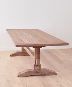 a wooden table sitting on top of a hard wood floor