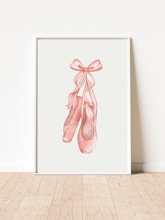 a watercolor painting of ballet shoes with a pink bow