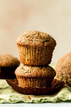 three muffins stacked on top of each other in front of another muffin