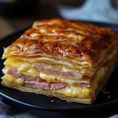 a stack of food sitting on top of a black plate