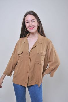 "Vintage minimalist brown blouse, retro summer shirt, Size L Welcome to TARASCOMMON.ETSY.COM Unique clothing from the 20th century.   Model tall - 170cm   Size: L. Sleeve - 30cm / 11.81inch; ( armpit to end of sleeve); Width - 56cm / 22.04inch; Length - 64cm / 25.19inch.    All measurements are taken seam to seam while lying flat.   Viscose. This item is vintage, so it can have some defects. Additional photos can be send   We are glad that you are interested in lots that we sell. Wish you a good Brown Camp Collar Top For Work, Classic Brown Collared Blouse, Classic Collared Brown Blouse, Brown Summer Workwear Blouse, Brown Collared Spring Blouse, Summer Workwear Brown Blouse, Spring Collared Brown Blouse, Brown Collared Blouse For Spring, Collared Brown Blouse For Spring