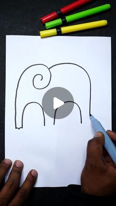 someone is drawing an elephant with crayons