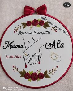 a wedding gift for the bride and groom is embroidered onto a white wall hanging ornament