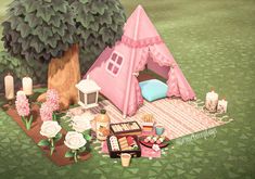 a pink tent sitting on top of a lush green field next to a small tree