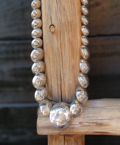 These Silver graduated beads, are hand stamped and rounded in to a simple but elegant necklace. Traditional Navajo silversmith techniques were used to create this beautiful vintage necklace that was created in the 90's but never worn. Length: 19.5" 64 grams Beads vary in size: 1/4" to 1 1/4" Vintage 1990's, never worn Silver Sterling Silver Round Beaded Necklaces, Silver Sterling Silver Beaded Necklace, Round Sterling Silver Beaded Necklace, Sterling Silver Single Strand Beaded Necklaces, Sterling Silver Round Beaded Single Strand Necklace, Round Sterling Silver Single Strand Beaded Necklace, Sterling Silver Round Beads Necklace For Anniversary, Silver Jewelry With Polished Beads And Round Pendant, Silver Necklace With Polished Round Beads