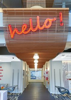 the inside of an office building with a neon sign that says hello