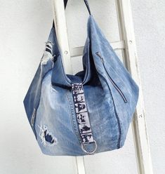 a denim bag hanging up on a ladder