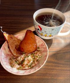 a cup of tea and some food on a plate