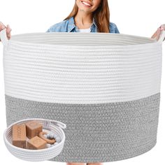 a woman holding up a large white and grey basket with two different colors on it