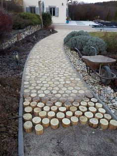 a pathway made out of wooden logs and gravel