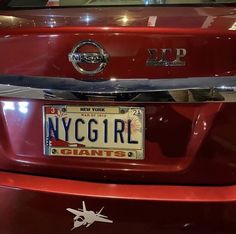 a red car with a license plate that says new york girl giants on the front