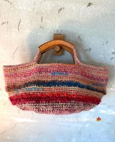 a multicolored purse hanging on a wall