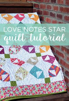 the love notes star quilt is on display in front of a brick wall with text overlay