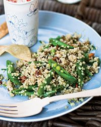 a blue plate topped with green beans and rice next to a cup filled with sauce